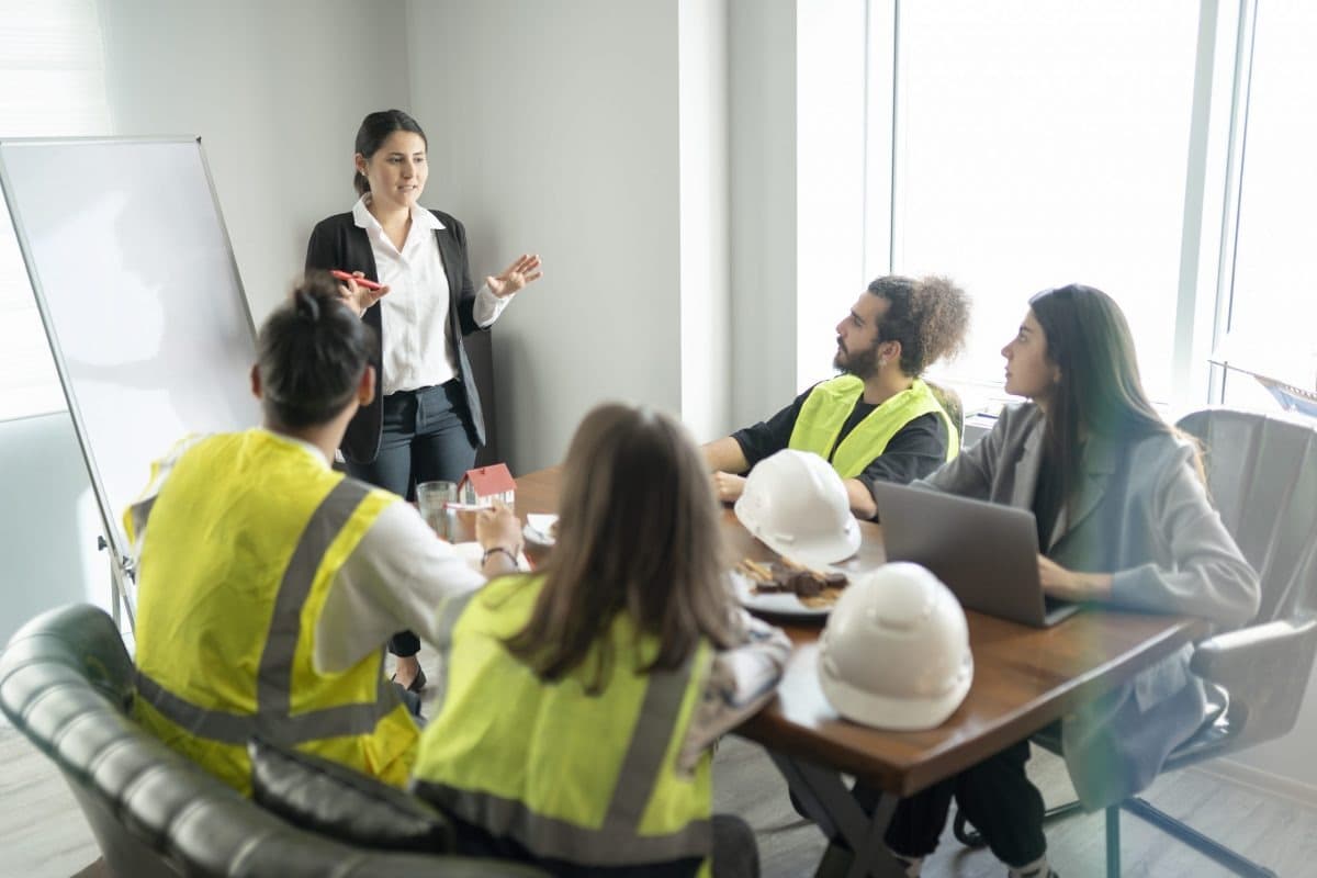 Salient leading a workplace safety meeting with a crew in hi-vis